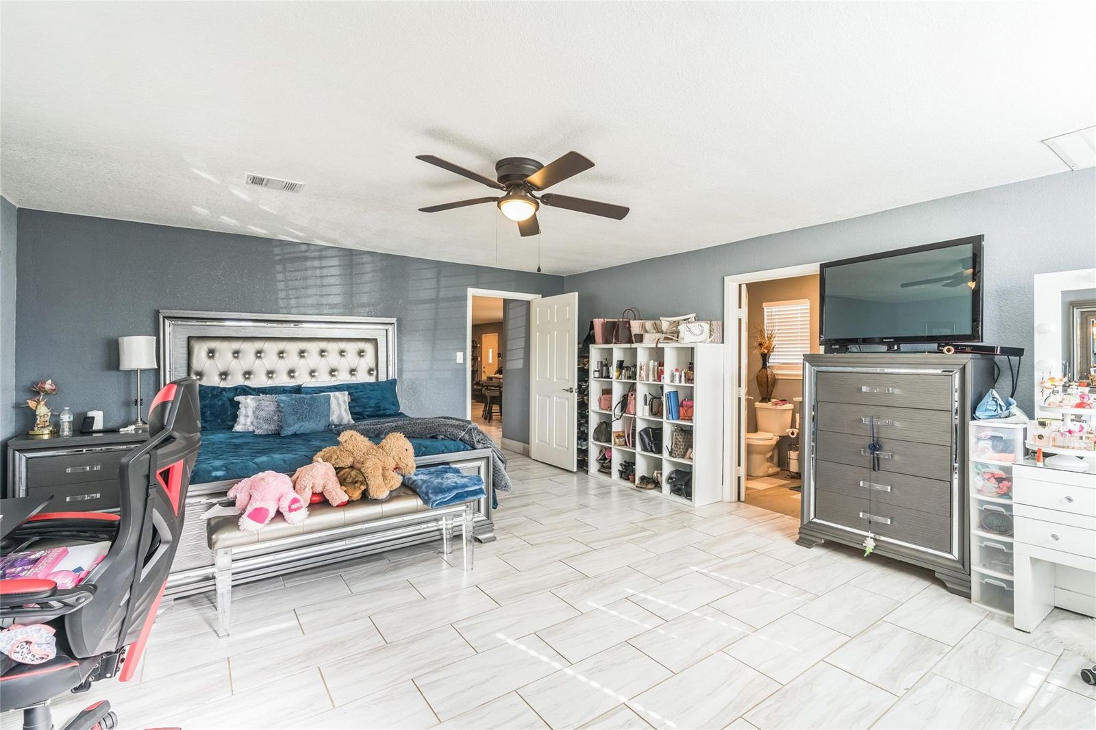 Bedroom with a ceiling fan and two windows