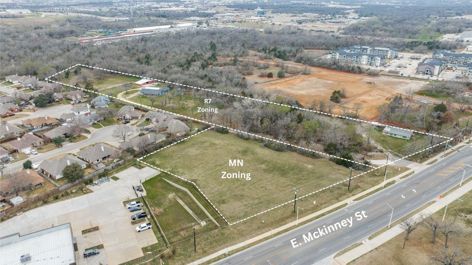 MN lot by the main road, with neighborhoods around it